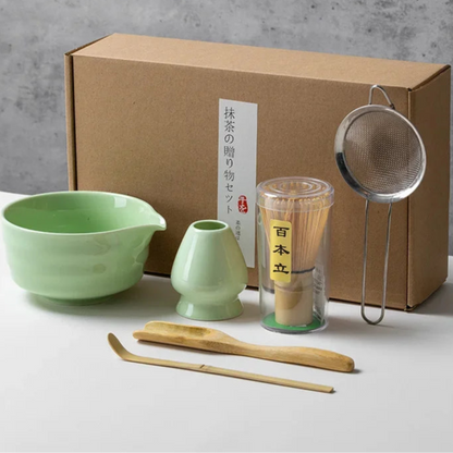 Light green tea-making set with box on a gray background