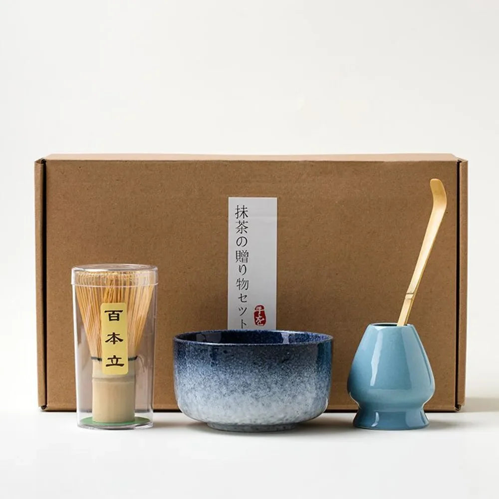 Matcha tea gift set with blue ceramic bowl bamboo whisk and scoop placed in front of a gift box