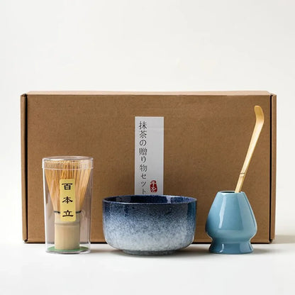 Matcha tea gift set with blue ceramic bowl bamboo whisk and scoop placed in front of a gift box
