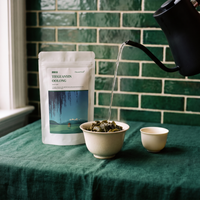 Water poured from a kettle into a gaiwan of Tieguanyin oolong leaves